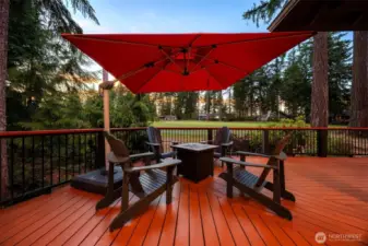 Twilight view of the inviting seating area and outdoor fireplace.