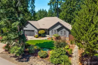 Aerial view of front of home -- beautiful landscaping with a sprinkler sytem.