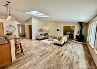 Great room offers wood stove, double doors lead to large primary suite.