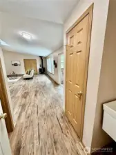 Looking from garage entrance to great room.  Toilet room to the left and laundry sink to the right.