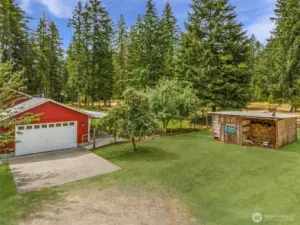 Attached 2 car garage, chicken coop, wood storage and more space in the rear of out building. Mature Cherry and Apple trees too.
