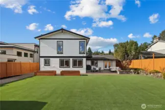 Massive level turf backyard. Raised planters have drip irrigation and both side yards are generously sized. There are storage closets on the right for lawn/garden equipment and a bike shed on the left with room for additional storage if desired.