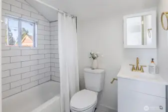 Completely remodeled bathroom featuring new tile shower surround, modern fixtures, and a clean, timeless design.