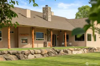 Covered back patio with fireplaces, propane hookups, utility sink w/ hot and cold water and more.