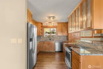 Granite counters with plenty of counter space and enough cabinets to store all your needs.