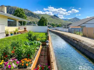Spring time is coming.  Irrigation canal borders the back fence  Virtually staged