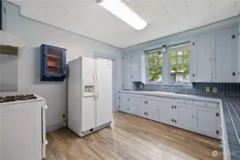 Kitchen featuring original cabinets, including ice box.