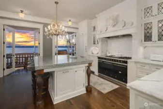 The kitchen, true heart of the home, is a true masterpiece of elegance and function. Wavy glass and custom lead doors were meticulously selected to adorn the room cabinetry made of Dovetail solid wood. Note the antique crystal chandelier above the island, a stunning piece which was taken from a 1909 Dutch Colonial home in West Seattle.