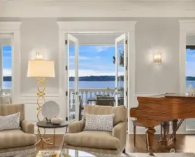 The west facing side of the living room opens onto the covered porch through three sets of French doors.