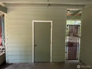 Storage shed in carport.