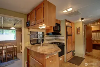 Great view of kitchen and front enclosed area