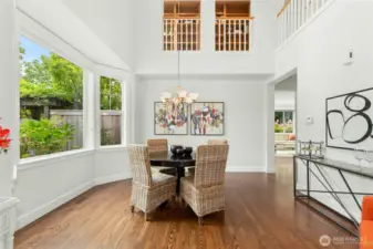 Formal dining room with a high ceiling and large windows