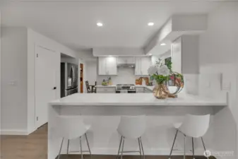 Spacious pantry conveniently located beside refrigerator.