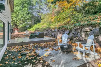 Relax in the private backyard featuring a new deck, seating area & fire pit.