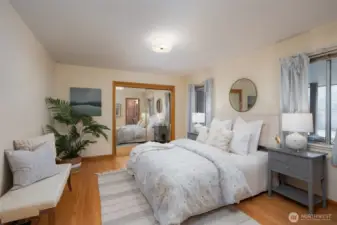 Main floor second bedroom suite.  Large closets and view of back yard and patio.