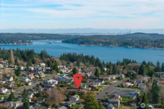 View east through Rich Passage, southern tip of Bainbridge Is and Port Orchard.  City of Seattle skyline in distance.  Passenger & car ferries leave multiple times a day from Bremerton to Seattle.