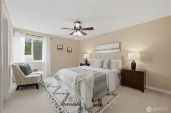 Primary bedroom with large closet and ceiling fan.