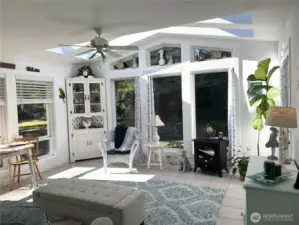 Sunroom with two large skylights and windows.  It is a delightful room.