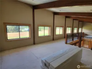 Upper loft office/sitting area at staircase crest, open beam ceilings with tongue and groove fir ceilings and recessed can lighting coming soon.  Generously placed alder wrapped windows bring in plenty of natural light.