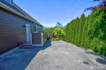 Additional parking to the right of the 3 bay garage. Short term RV parking due to HOA rules
