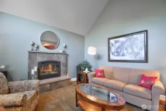 Formal living room with gas fireplace to the left of the entry