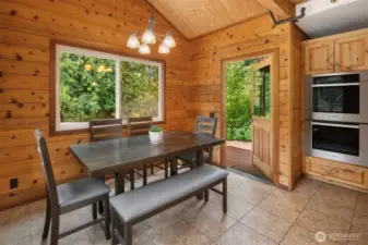 Eating nook off of kitchen with direct access to back deck.