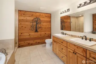 Full ensuite bath with two sink countertop off of primary bedroom.