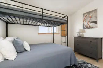The 2nd bedroom with space for guests/kids and laundry area