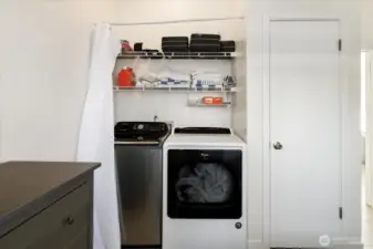 Laundry area hidden behind a curtain in the 2nd bedroom.