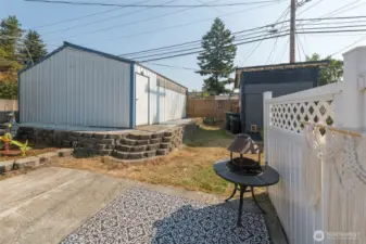 Backyard features dog kennel for pet convenience, as well as a shed with loft providing versatile storage space.