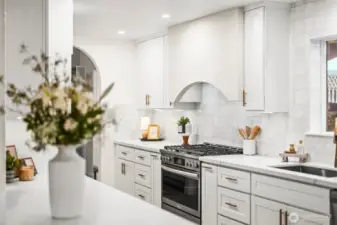 Large kitchen with custom range hood vent