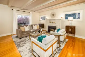 Entertain and live in style! The gracious living room is complete with coffered ceilings, picture window, and original fireplace with gas insert.