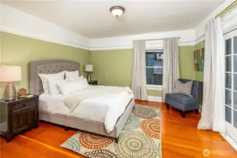 Upstairs features three bedrooms. The primary accesses the private, fully covered patio through French doors.