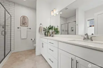 Double vanity, separate tiled shower and garden tub
