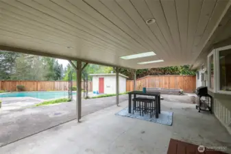 Large covered patio with skylights and overhead lighting