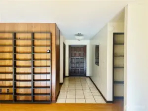 Entry area of home, showing built  in shelving in living room