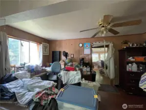 Large living room. Big windows for lots of natural light. Kitchen straight ahead and hall leading to bathroom, laundry, and another door to the master will be on the right.