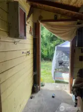 Back porch area, leading from kitchen. Large outbuilding will be on the right.