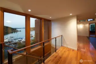 Main floor landing with views over Seattle Yacht Club toward Mount Baker. Architect's use of windows allows views from every room (living room, primary bedroom, kitchen, landing).