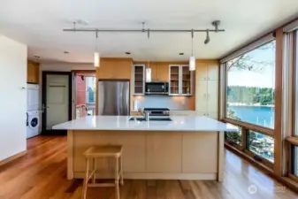 Guest apartment has kitchen, large counter island, propane oven, refrigerator, microwave and stackable washer and dryer.