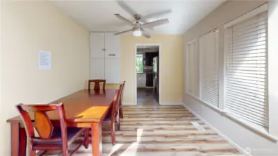 Ceiling fan and laminate wood flooring in the dining area.