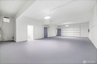 Extra large workshop space on lower level including bathroom with shower.