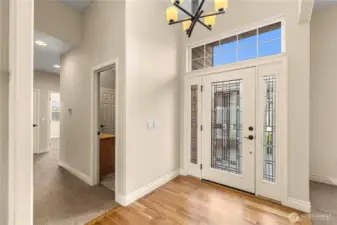 Entry is four inch cherry through kitcxhen, living and dining.  Note hallway to main bath and bedroom wing.