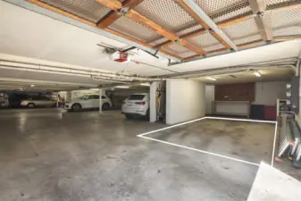 Dedicated oversized garage bay with tool bench and extra storage shelves