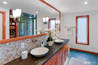 Primary bathroom has double sinks and slate heated floors.