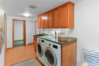 New flooring and baseboards in laundry room.
