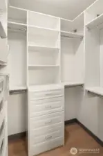 Custom built-ins maximize storage in the walk-in closet.