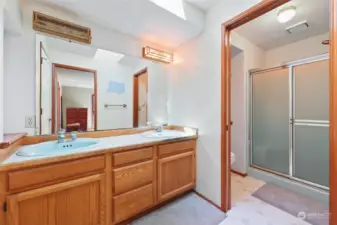 Primary Bathroom with double sink vanity. Pocket door provides privacy to shower & toilet.