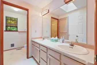 Main hallway bathroom. Pocket door separates tub/shower & toilet area from double-sink vanity.