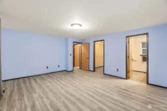 This is the large primary bedroom. The middle door is a big walk in closet, and the door on the right is the entrance to the primary bathroom.